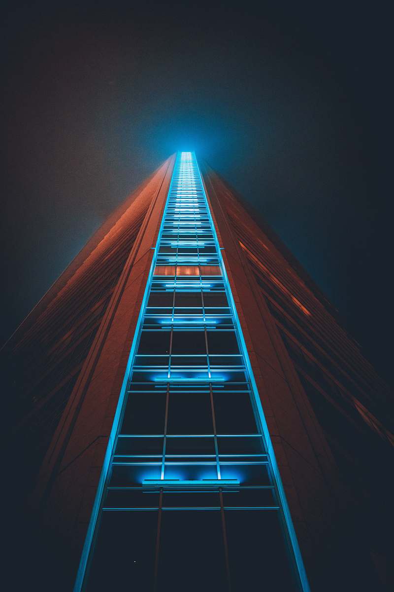 office building low angle photography of lighted high rise building city